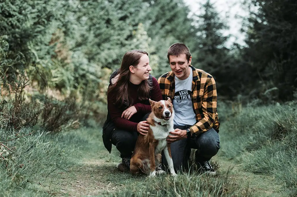 Couple in Woodland Welshpool, Powys with their Welsh Collie dog