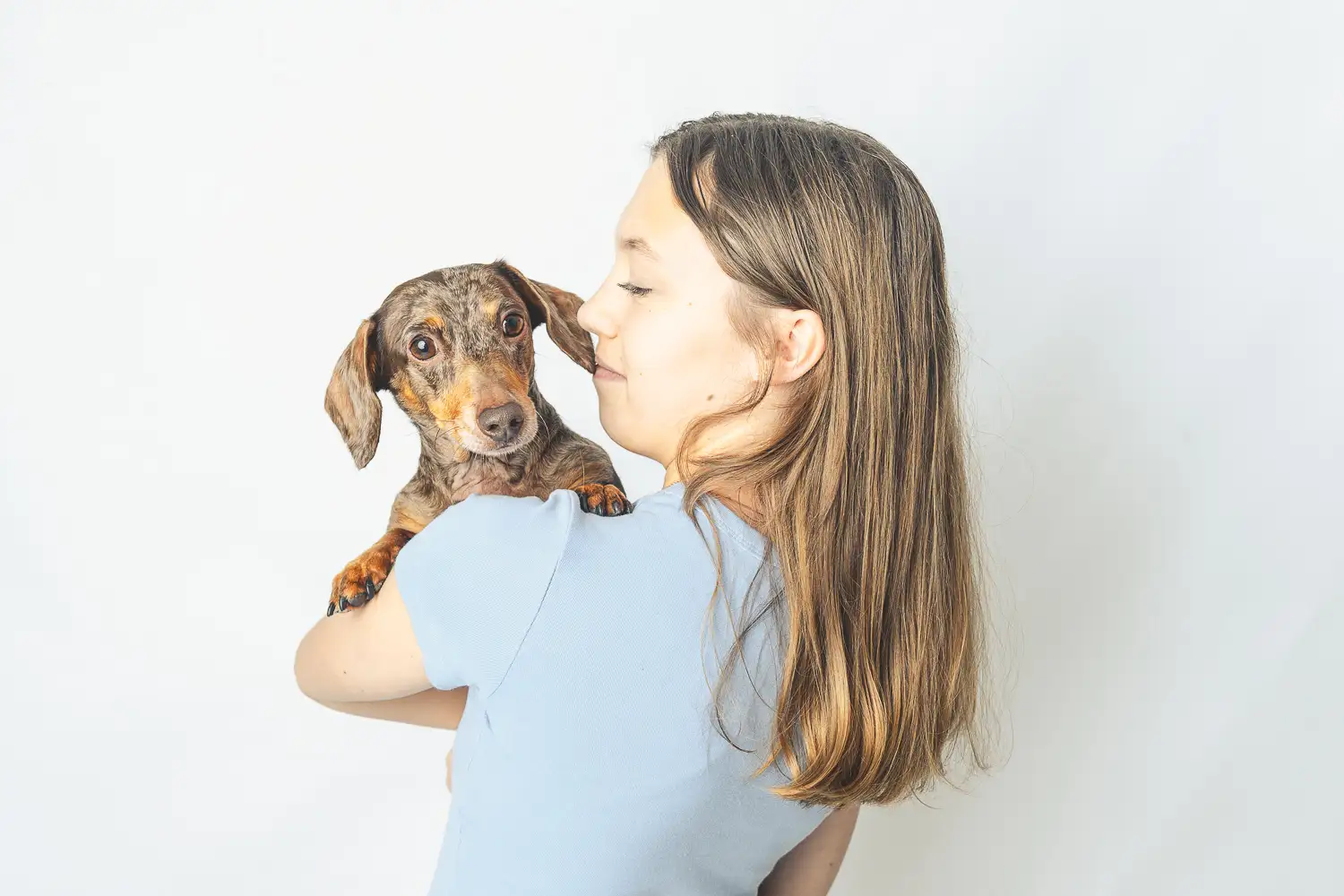girl with dachshund in studio
